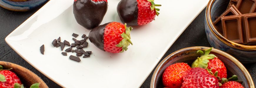 Chocolate covered strawberries on a plate.