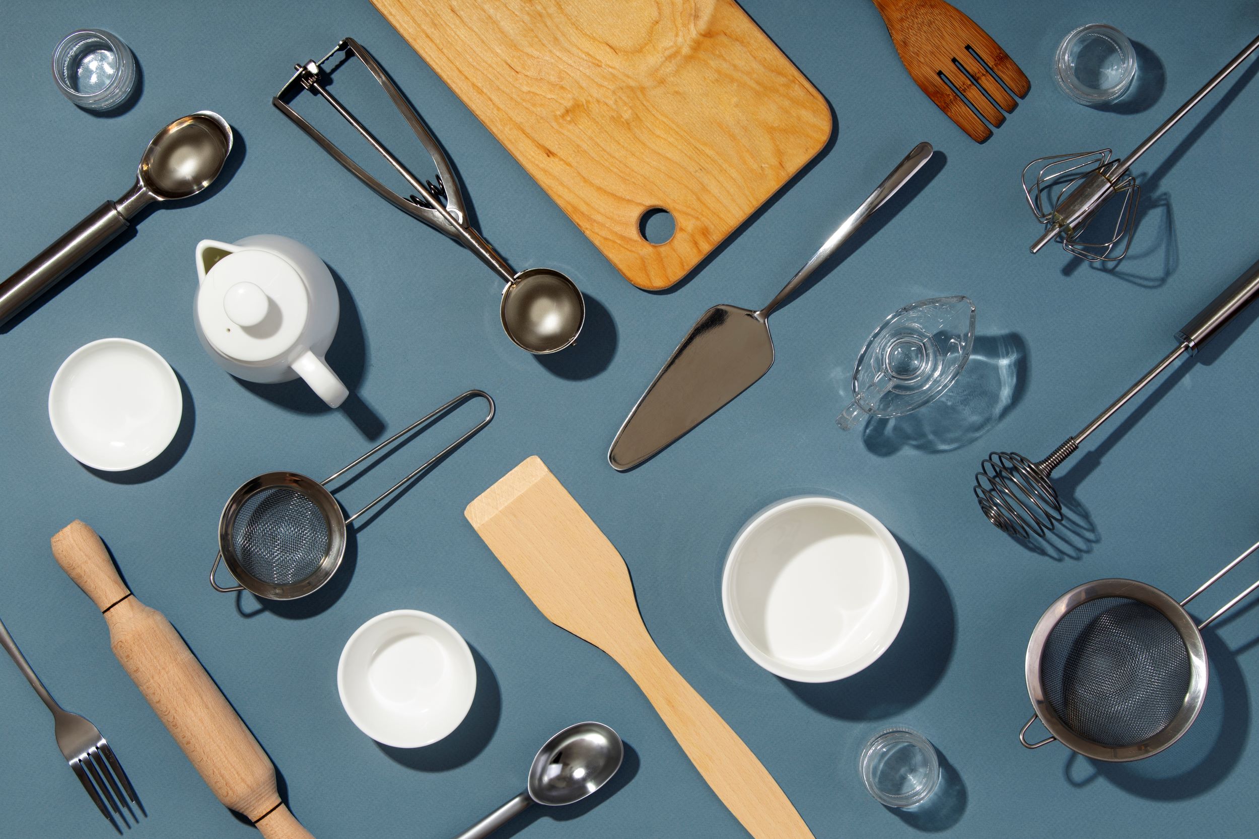 Kitchen accessories laid out on a blue counter